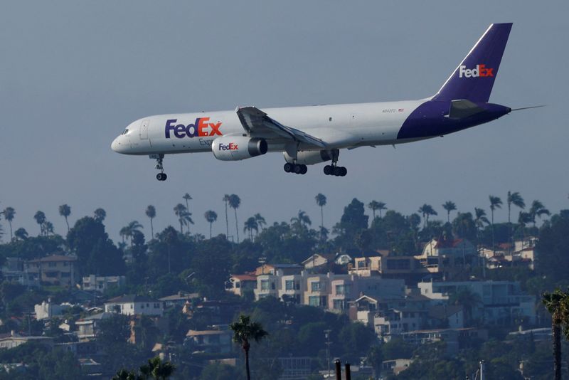 FILE PHOTO: A Federal Express cargo plane approaches to land in San Diego, California August 24, 2020.  REUTERS/Mike Blake/File Photo