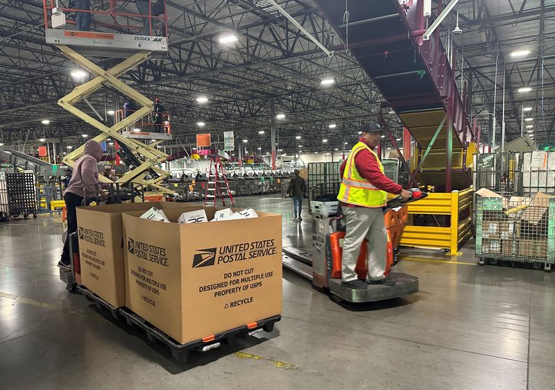 Employees work as the largest United States Postal Service (USPS) facility gears up for the busiest shipping time of the year, in Los Angeles, California, U.S. November 30, 2023. REUTERS/Jorge Garcia