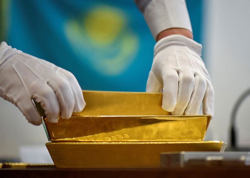 FILE PHOTO: An employee places gold bars in the Kazakhstan's National Bank vault in Almaty, Kazakhstan, September 30, 2016.  REUTERS/Mariya Gordeyeva/File Photo