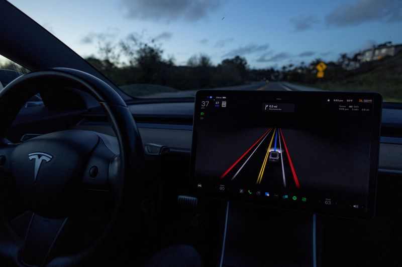 A Tesla Model 3 vehicle is shown using the Full Self Driving Beta software (FSD) while navigating a city road in Encinitas, California, U.S., February 28, 2023. REUTERS/Mike Blake