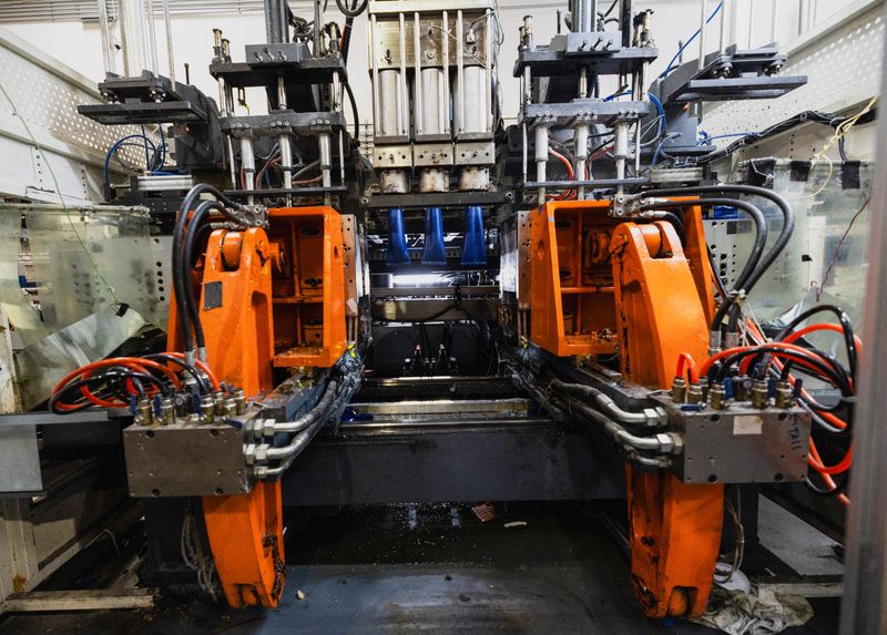 A factory machine of Valencia Plastics creates wide mouth canisters, in Rye Canyon, in Valencia, California, U.S. December 23, 2025.  REUTERS/Aude Guerrucci