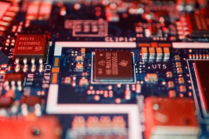 Semiconductor chips are seen on a circuit board of a computer in this illustration picture taken February 25, 2022. REUTERS/Florence Lo/Illustration