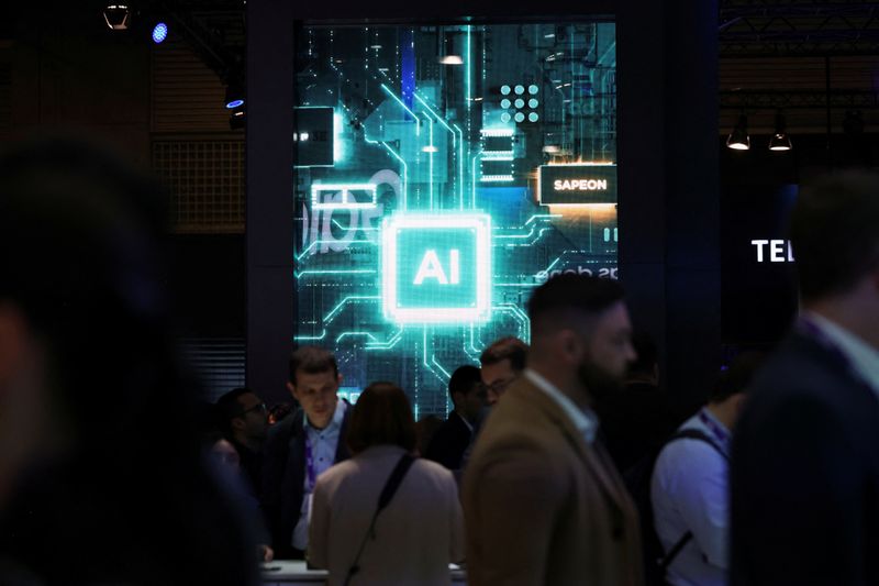 People walk near a sign for Sapeon, an artificial intelligence (AI) chip company, at the Mobile World Congress (MWC) in Barcelona, Spain, February 27, 2024. REUTERS/Bruna Casas