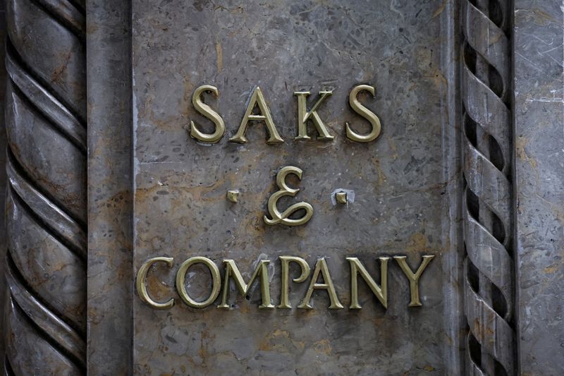 FILE PHOTO: A sign on the facade of the entrance to the Saks Fifth Avenue flagship store, after the store filed for bankruptcy protection, in New York City, U.S., January 14, 2026.  REUTERS/Brendan McDermid/File Photo