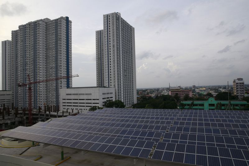 FILE PHOTO: Solar panels are seen on the roof deck of a mall in Quezon city, metro Manila July 13, 2015. REUTERS/Romeo Ranoco/File Photo