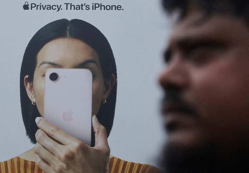 A man walks past an Apple iPhone hoarding on a street in Mumbai, India, June 29, 2026. REUTERS/Francis Mascarenhas