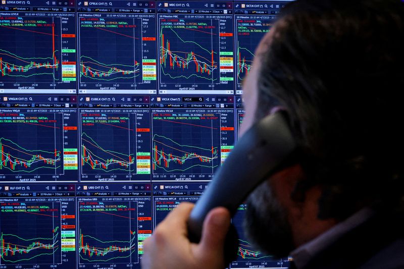 FILE PHOTO: A trader works on the floor at the New York Stock Exchange in New York City, U.S., April 8, 2025.  REUTERS/Brendan McDermid/File Photo