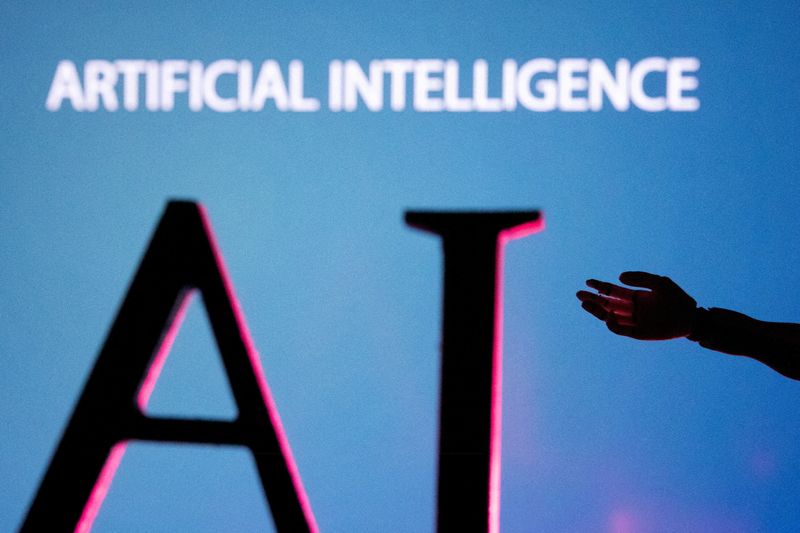 FILE PHOTO: AI (Artificial Intelligence) letters and robot hand miniature in this illustration taken, June 23, 2023. REUTERS/Dado Ruvic/Illustration/File Photo