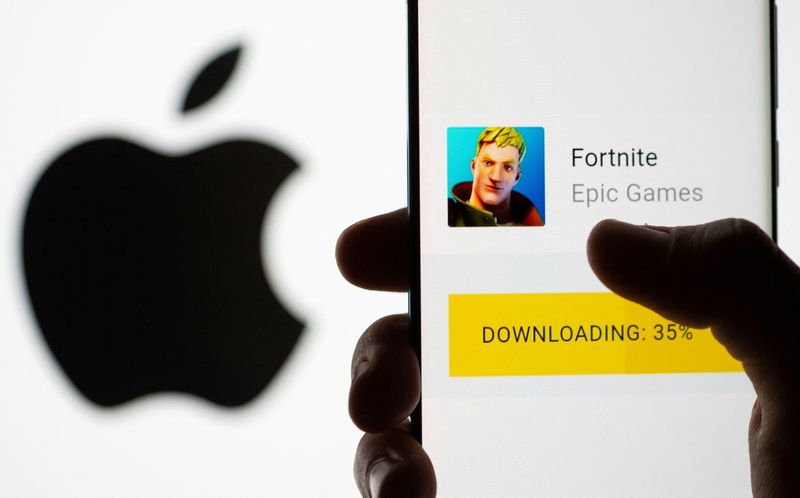 FILE PHOTO: Fortnite game download on Android operating system is seen in front of Apple logo in this illustration taken, May 2, 2021. REUTERS/Dado Ruvic/Illustration/File Photo