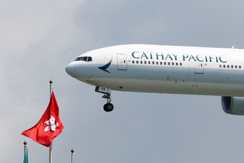 FILE PHOTO: A Cathay Pacific Boeing 777-300ER plane lands at Hong Kong airport, in Hong Kong, China August 14, 2019. REUTERS/Thomas Peter/File Photo