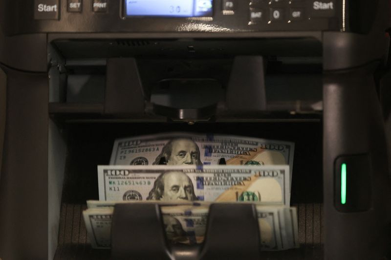 FILE PHOTO: Dollar bills are seen in a currency-counting machine at a currency exchange, in Tehran, Iran, October 5, 2025. Majid Asgaripour/WANA/File Photo
