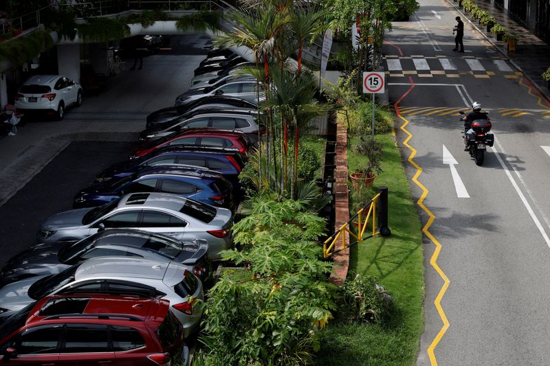 FILE PHOTO: Cars for sale are parked at used car dealerships in Singapore October 17, 2022. REUTERS/Edgar Su/File Photo