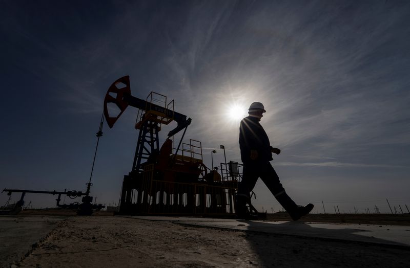 FILE PHOTO:  An oil and gas industry worker walks during operations of a drilling rig at Zhetybay field in the Mangystau region, Kazakhstan, November 13, 2023. REUTERS/Turar Kazangapov/File Photo