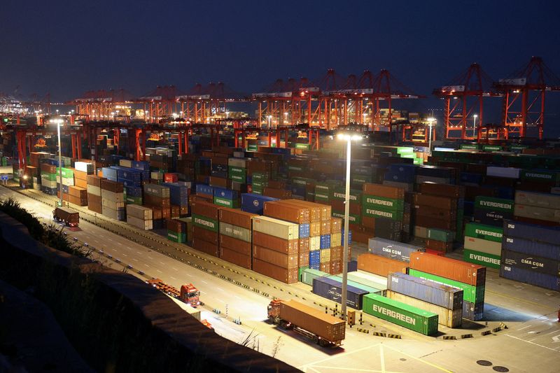 FILE PHOTO: Gantry cranes stand near stacked shipping containers at Yangshan Port outside Shanghai, China, May 7, 2026.  REUTERS/Go Nakamura/File Photo