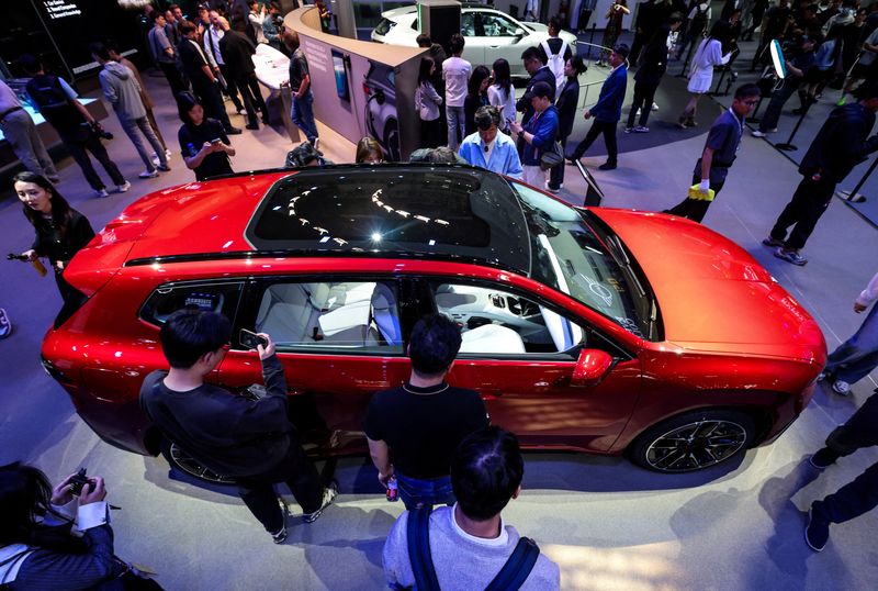 FILE PHOTO: People gather around the BMW iX3 model at the company’s booth at the Beijing International Automotive Exhibition (Auto China), in Beijing, China, April 24, 2026. REUTERS/Maxim Shemetov/File Photo