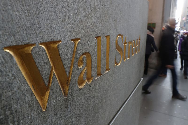 FILE PHOTO: A street sign, Wall Street, is seen outside New York Stock Exchange (NYSE) in New York City, New York, U.S., January 3, 2019. REUTERS/Shannon Stapleton/ File Photo
