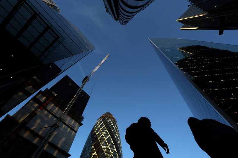 FILE PHOTO: People walk through the City of London business district in London, Britain, November 21, 2025. REUTERS/Toby Melville/ Fle Photo