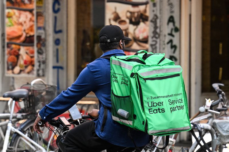 A food delivery cyclist with an Uber Eats backpack rides a bike in Berlin, Germany, July 16, 2026. REUTERS/Annegret Hilse