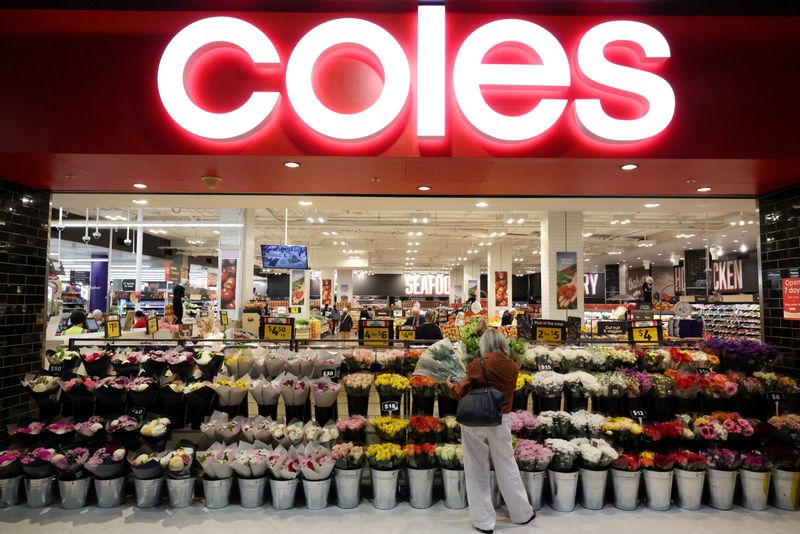 FILE PHOTO: A woman shops for flowers at a Coles supermarket in Bondi Junction, ahead of Coles Group announcing their first-quarter sales results, in Sydney, Australia, October 29, 2025. REUTERS/Hollie Adams/File Photo
