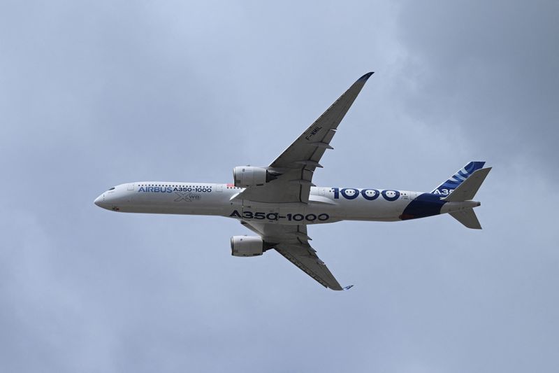 An Airbus A350-1000 flies during the Farnborough Airshow, in Farnborough, Britain, July 21, 2026. REUTERS/Jaimi Joy