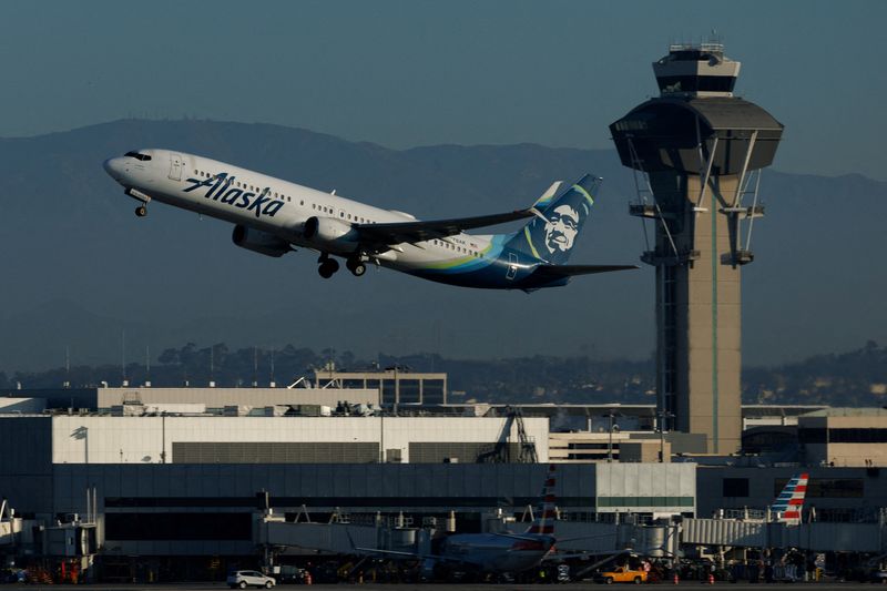 FILE PHOTO: An Alaska Airlines commercial airliner takes-off from Los Angeles International Airport in Los Angeles, California, U.S., November 6, 2025. REUTERS/Mike Blake/File Photo