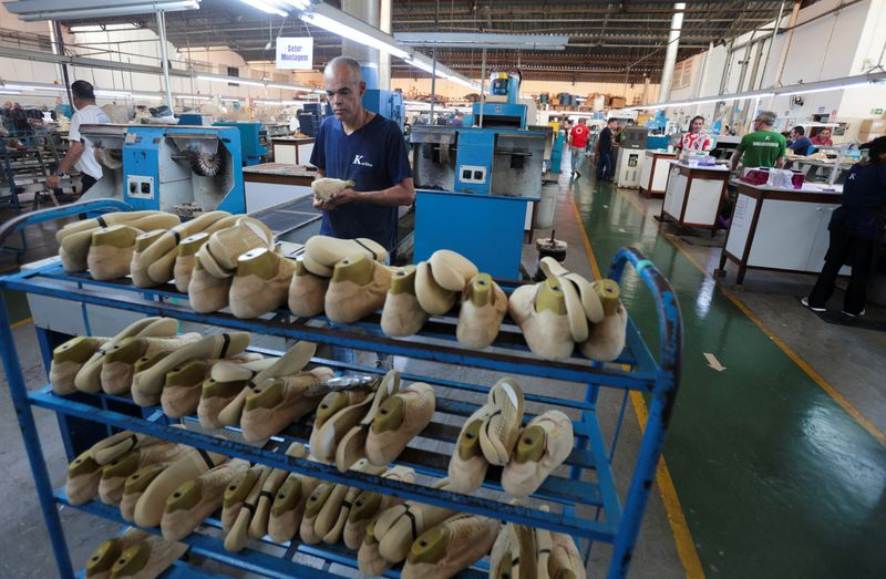 A worker inspects shoes at Brazilian footwear manufacturer Kissol, as new U.S. tariffs are set to hit a range of Brazilian goods, including the footwear industry, which counts the U.S. as its top foreign market, in Franca, Sao Paulo state, Brazil, July 17, 2026. REUTERS/Joel Silva