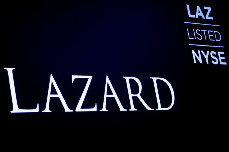 FILE PHOTO: The logo and trading information for Lazard Ltd appear on a screen on the floor at the New York Stock Exchange (NYSE) in New York, U.S., April 24, 2019.REUTERS/Brendan McDermid/File Photo