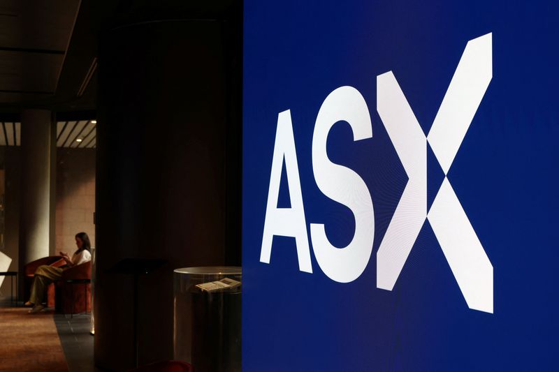 A woman sits near an ASX logo, displayed at the Australian Securities Exchange, in Sydney, Australia, April 22, 2026. REUTERS/Hollie Adams