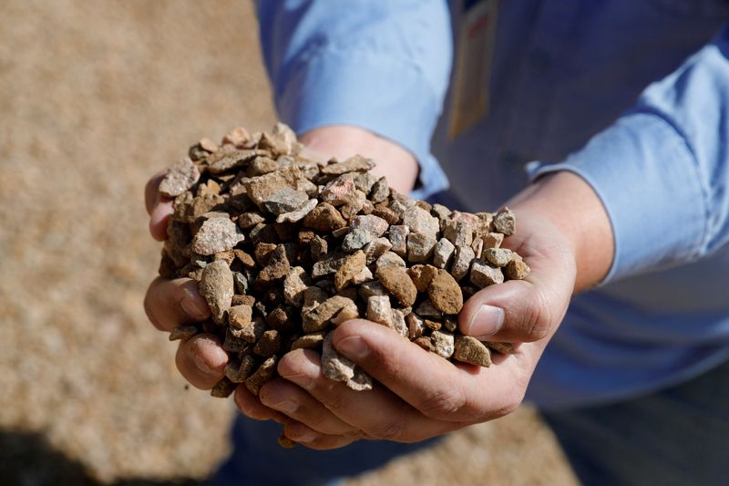 FILE PHOTO: Matt Green, mining/crushing supervisor at MP Materials, displays crushed ore before it is sent to the mill at the MP Materials rare earth mine in Mountain Pass, California, U.S. January 30, 2020. Picture taken January 30, 2020. REUTERS/Steve Marcus/File Photo