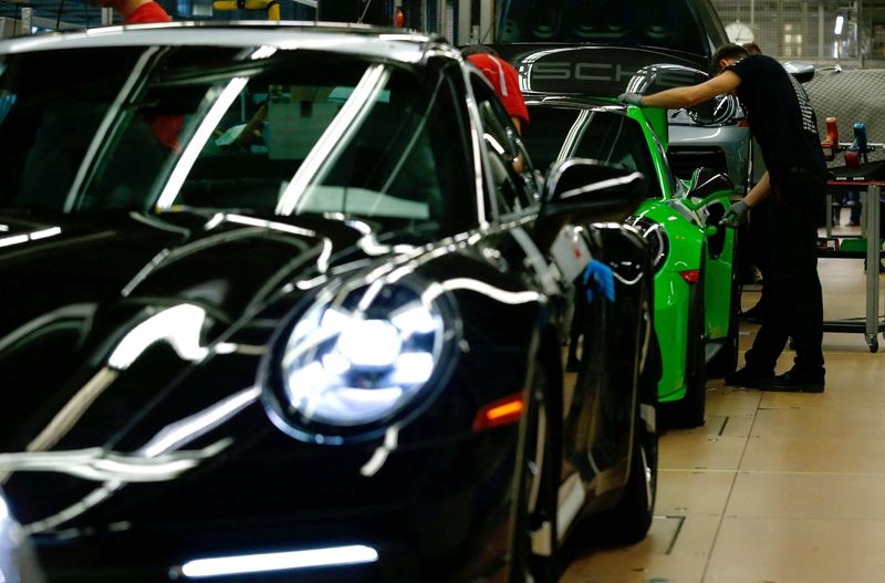 FILE PHOTO: Employees of German car manufacturer Porsche assemble sports cars at the Porsche factory in Stuttgart-Zuffenhausen, Germany, February 19, 2019. REUTERS/Ralph Orlowski/File Photo