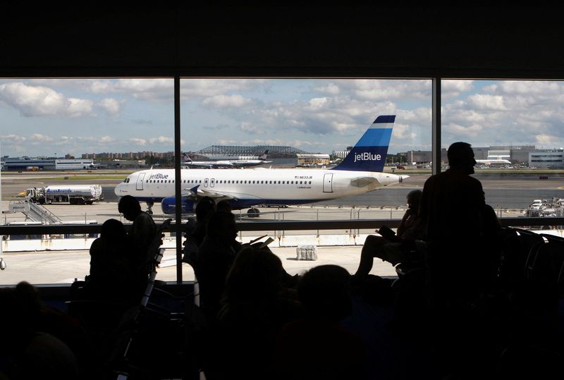 FILE PHOTO: People are seen in the new JetBlue Airways Terminal 5 at John F. Kennedy International Airport during a terminal test in New York August 23, 2008.  REUTERS/Joshua Lott/File Photo