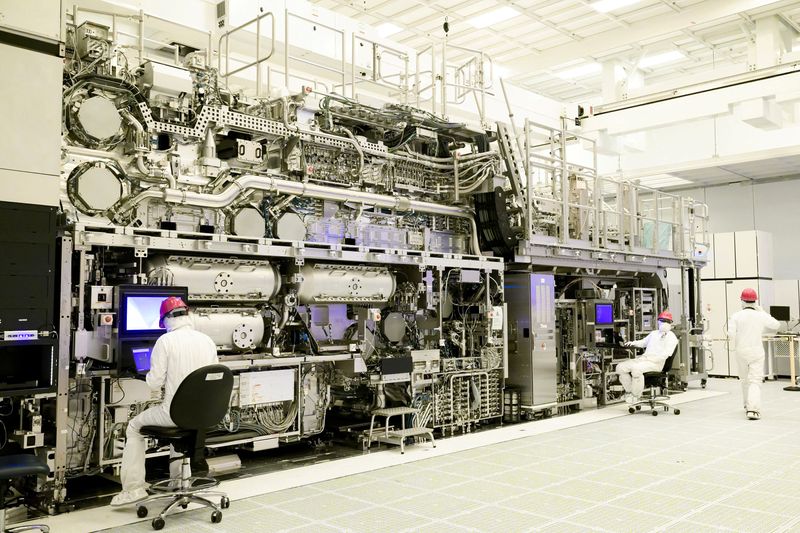 FILE PHOTO: Workers are seen in front of a "High NA EUV" lithography system at an Intel facility in Hillsboro, Oregon, U.S. in this handout image obtained by Reuters on April 19, 2024. Intel Corporation/Handout via REUTERS/File Photo