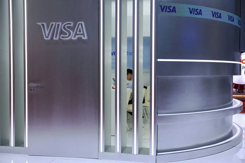 FILE PHOTO: A man sits in a room at the Visa booth during the China International Supply Chain Expo (CISCE) in Beijing, China June 22, 2026. REUTERS/Florence Lo/File Photo