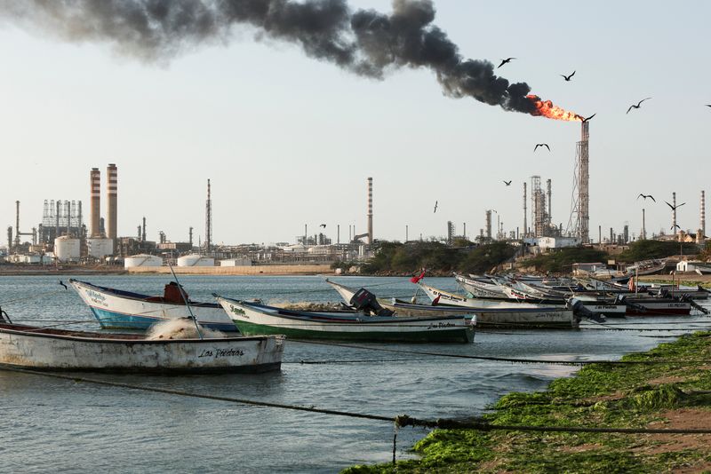 Fishing boats are moored on the shoreline near the Cardon refinery, part of the Paraguana Refining Center, as years of underinvestment, equipment failures and shortages have hampered fuel production in Venezuela, in Punta Cardon, Venezuela, May 6, 2026. REUTERS/Gaby Oraa