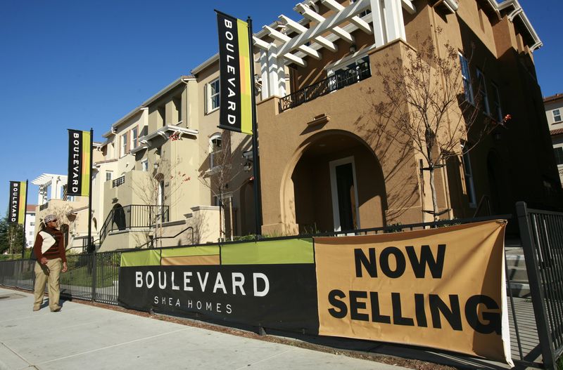 A pedestrian walks past a sign advertising new condominium homes for sale in South San Francisco, California December 22, 2009. REUTERS/Robert Galbraith