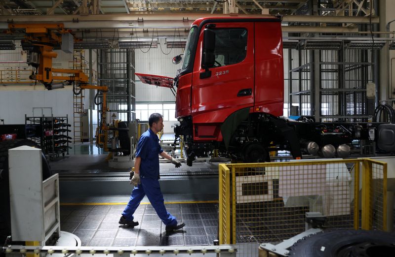 An employee walks at the truck assembly line at Beiben Trucks Group factory during an organized media tour, in Baotou, Inner Mongolia Autonomous Region, China, June 13, 2026. REUTERS/Maxim Shemetov
