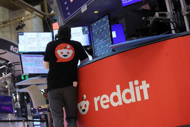 FILE PHOTO: A trader wears a t-shirt with Reddit's logo, at the New York Stock Exchange (NYSE) in New York City, U.S., March 21, 2024. REUTERS/Brendan McDermid/File Photo