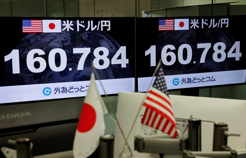 Monitors display the current Japanese Yen exchange rate against the U.S. dollar at a dealing room of the foreign exchange trading company Gaitame.com in Tokyo, Japan, July 31, 2026. REUTERS/Manami Yamada 