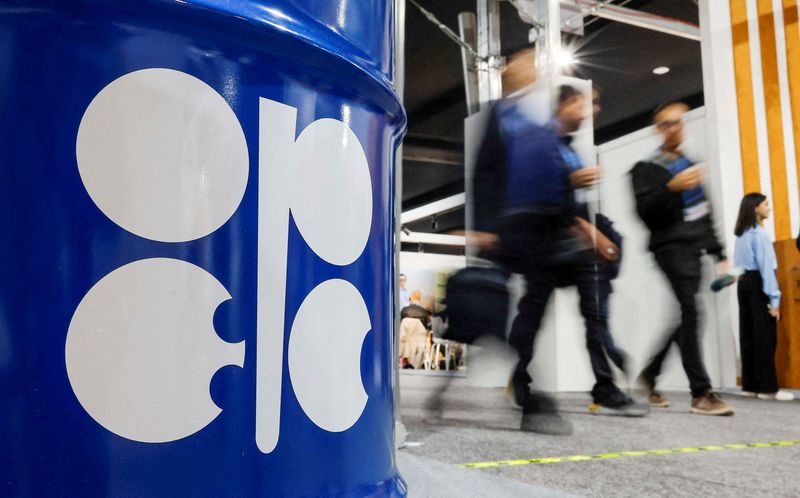 FILE PHOTO: People walk past an installation depicting barrel of oil with the logo of Organization of the Petroleum Exporting Countries (OPEC)  in Baku, Azerbaijan November 19, 2024. REUTERS/Maxim Shemetov/File Photo