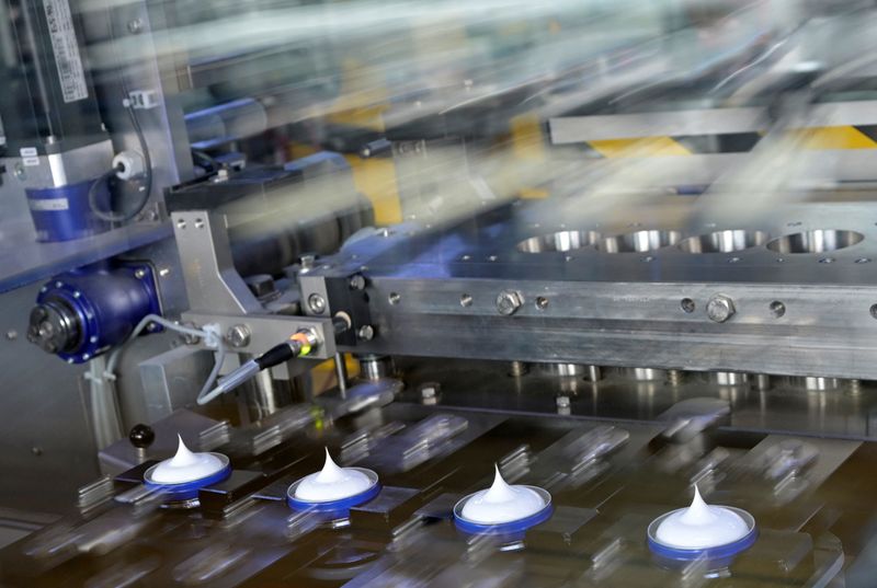 FILE PHOTO: Nivea tins are filled on a production line at the plant of German personal-care company Beiersdorf two days before the company's annual press conference in Hamburg, Germany February 25, 2025. Picture taken with long exposure. REUTERS/Fabian Bimmer/File Photo