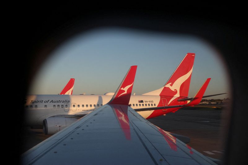 A Qantas logo is visible on the tail of an aeroplane at an airport in Sydney, Australia, September 18, 2025. REUTERS/Hollie Adams