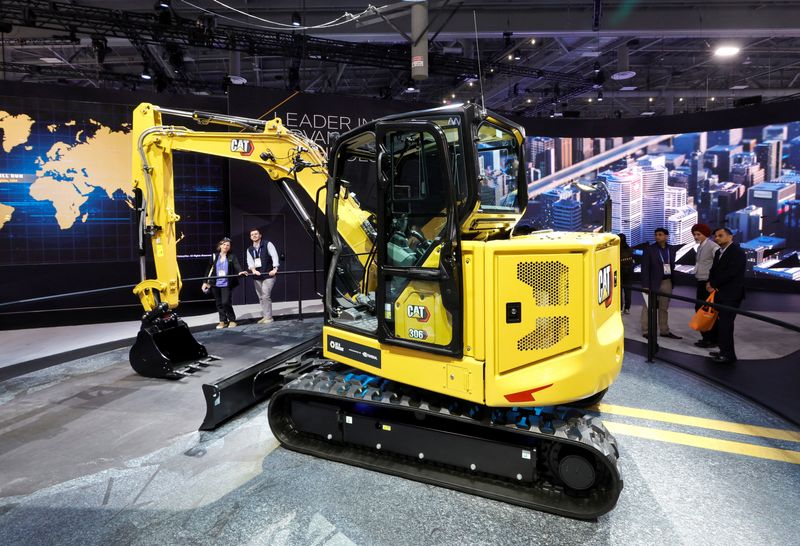 A couple looks at a Caterpillar 306 mini-excavator, with in-cab CAT AI Assistant, during CES 2026, an annual consumer electronics trade show, in Las Vegas, Nevada, U.S. January 7, 2026. REUTERS/Steve Marcus