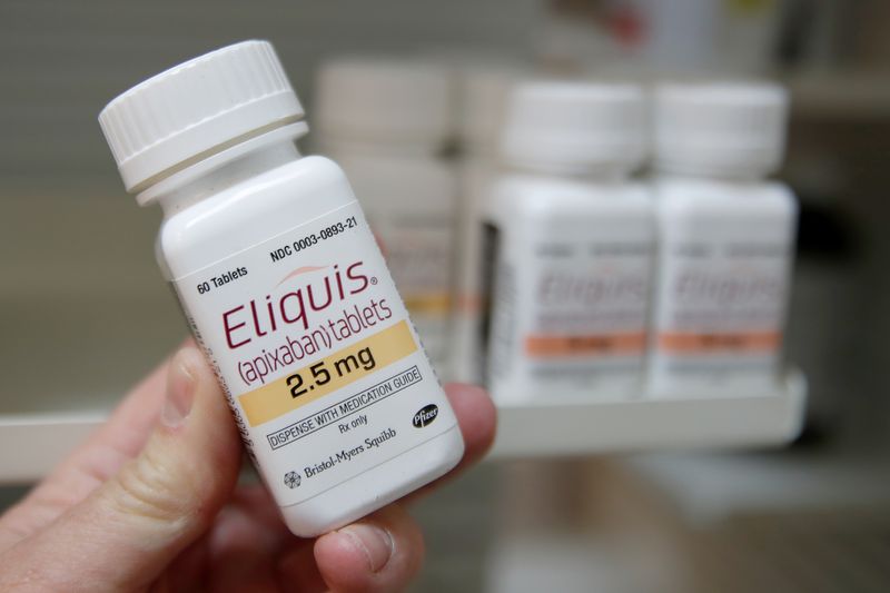 A pharmacist holds a bottle of the drug Eliquis, made by Pfizer Pharmaceuticals, at a pharmacy in Provo, Utah, U.S. January 9, 2020.   REUTERS/George Frey