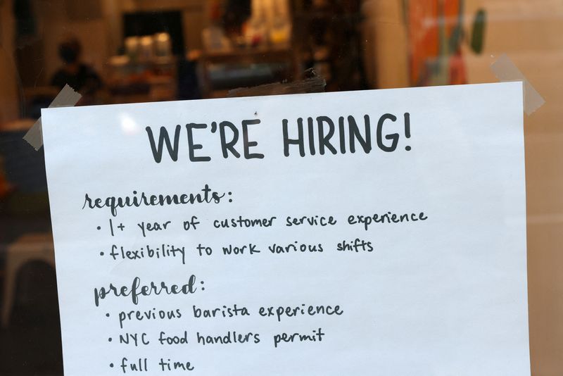 A hiring sign is seen in a cafe as the U.S. Labor Department released its July employment report, in Manhattan, New York City, U.S., August 5, 2022. REUTERS/Andrew Kelly