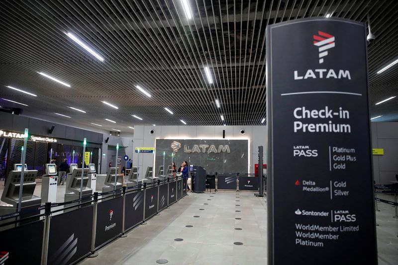 People stand at the departures area of Latam airlines inside the international airport in Santiago, Chile November 11, 2025. REUTERS/Rodrigo Garrido