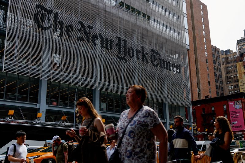 FILE PHOTO: People walk by The New York Times building in Manhattan, New York City, U.S., September 16, 2025.  REUTERS/Kylie Cooper/File Photo