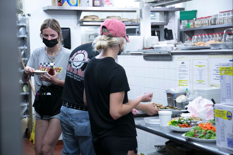 Employees work in an understaffed kitchen at Ramsi's cafe as many businesses face staffing shortages in Louisville, Kentucky, U.S., June 5, 2021. Picture taken June 5, 2021.  REUTERS/Amira Karaoud