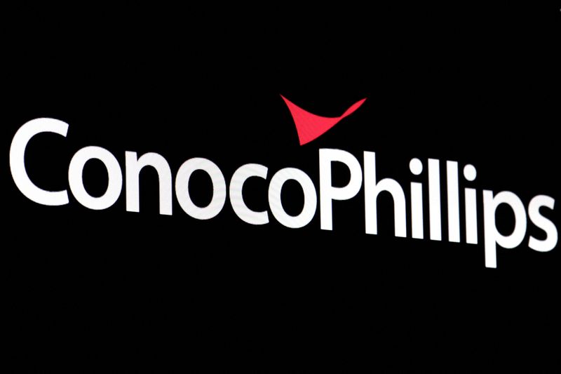 FILE PHOTO: A screen displays the logo for ConocoPhillips on the floor of the New York Stock Exchange (NYSE) in New York City, U.S., April 6, 2022. REUTERS/Brendan McDermid//File Photo