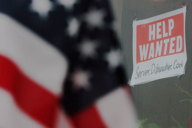 FILE PHOTO: A “Help Wanted” sign hangs in restaurant window in Medford, Massachusetts, U.S., January 25, 2023.     REUTERS/Brian Snyder/File Photo