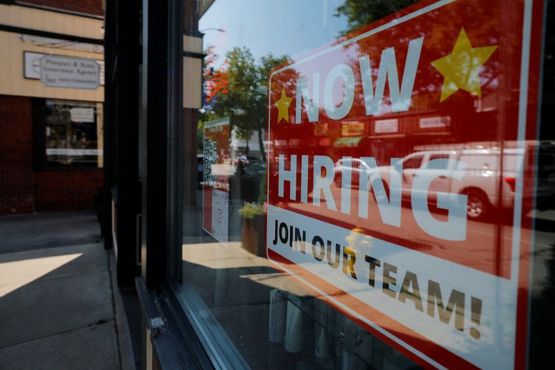 A "Now Hiring" sign hangs in the window of a hair salon in the Greater Boston town of Medford, Massachusetts, U.S., August 12, 2025.   REUTERS/Brian Snyder